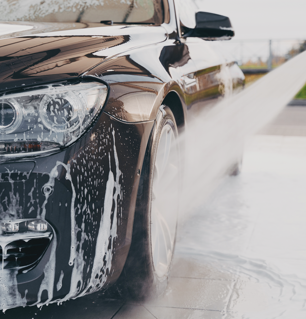 Car covered in soap foam during a wash